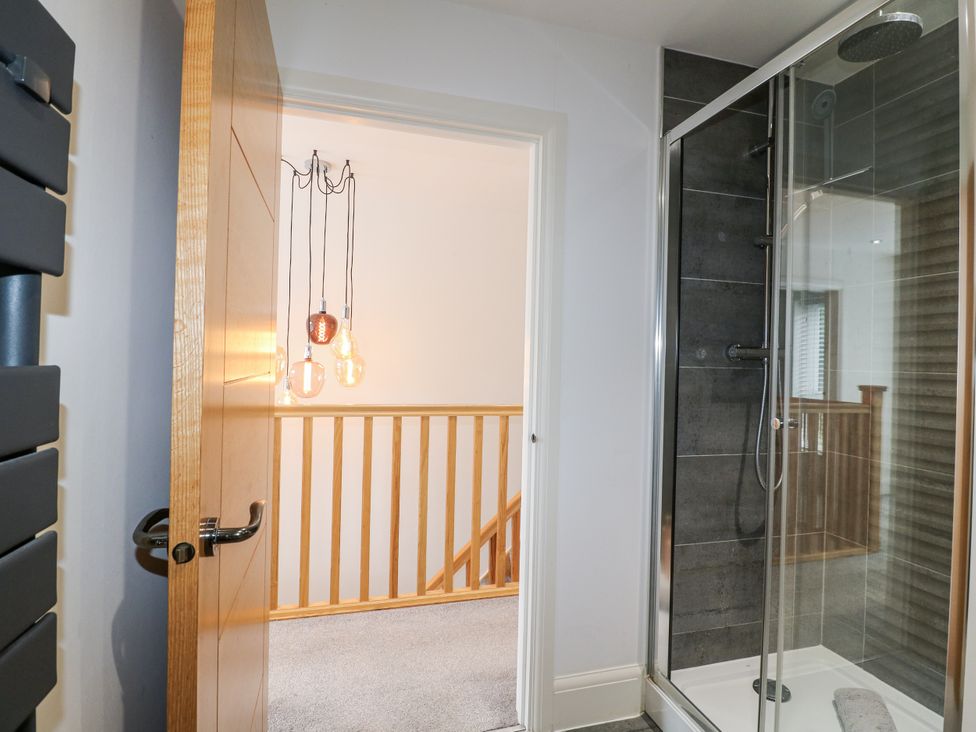 A bathroom with a shower and door at Rockcliffe Grange in Mansfield