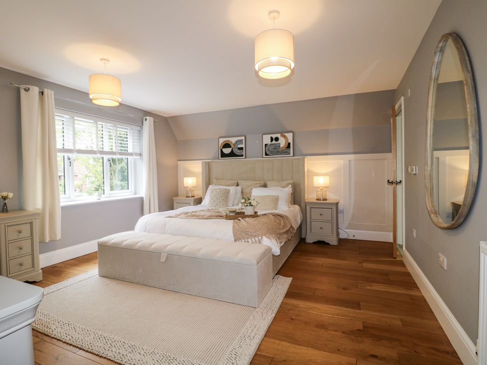 A bedroom with a bed and bedside tables at Rockcliffe Grange in Mansfield