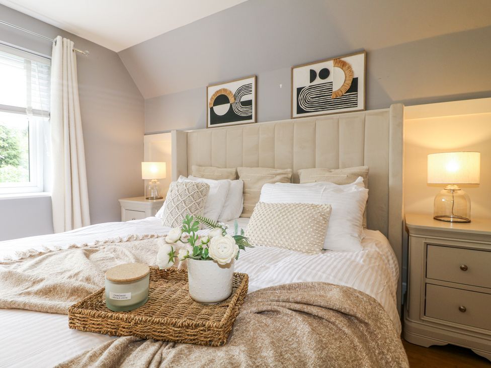 A bedroom with a bed and bedside table at Rockcliffe Grange in Mansfield