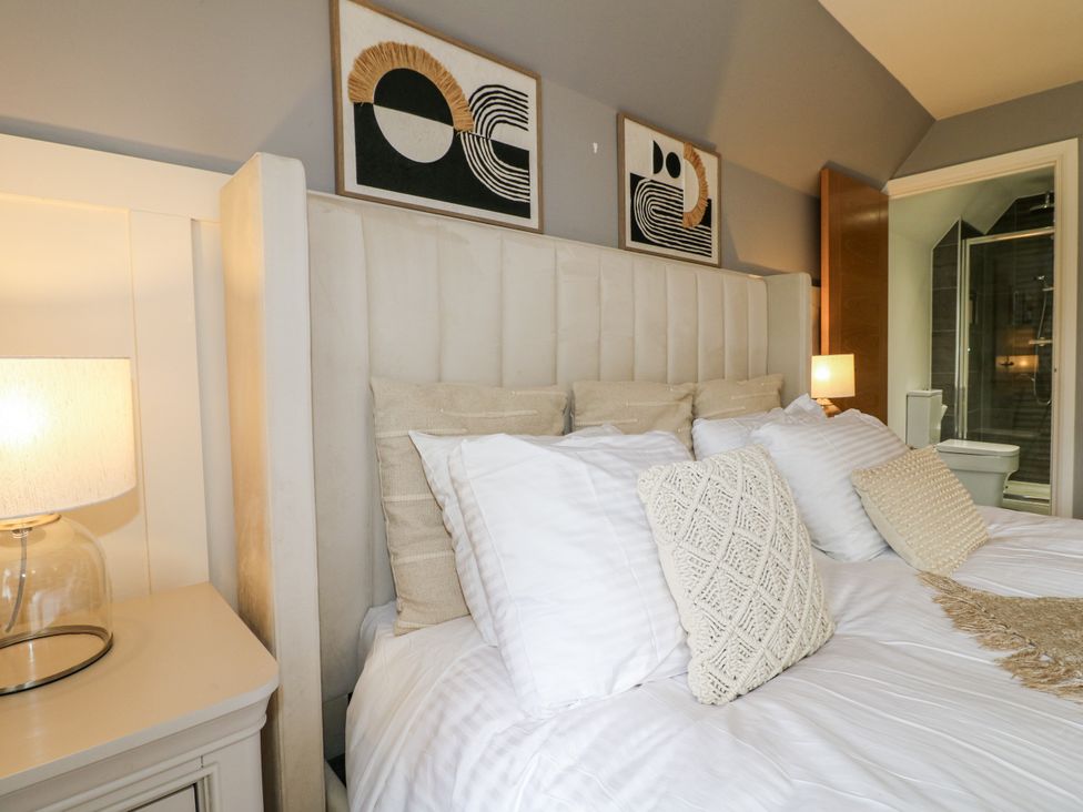 A bedroom with a bed and bedside lamp at Rockcliffe Grange in Mansfield