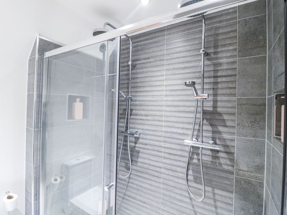 A shower with dual shower heads and wall niche at Rockcliffe Grange in Mansfield