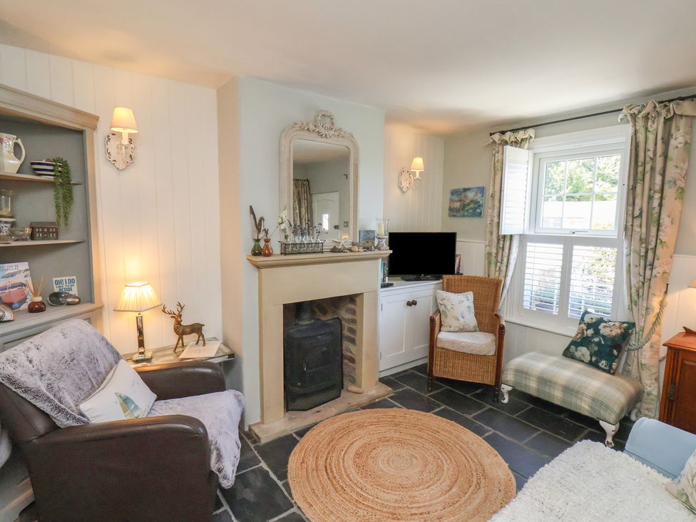 A living room with a fireplace and sofa at Woodbine Cottage in Whitby