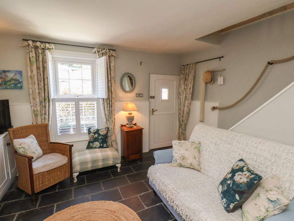 A living room with a sofa and armchair at Woodbine Cottage in Whitby
