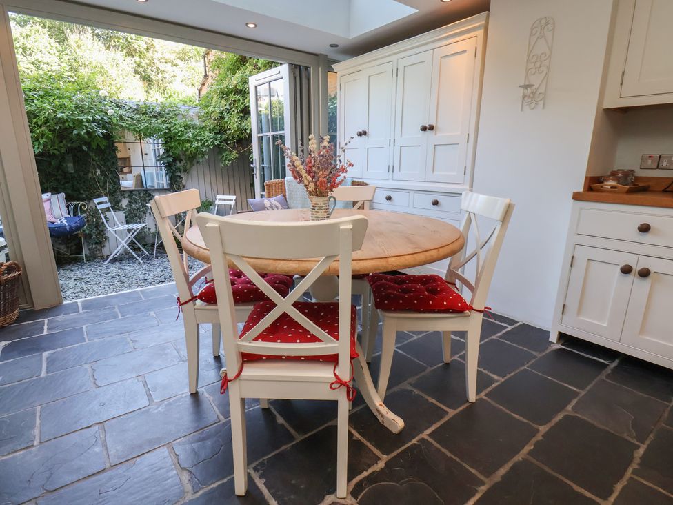 A kitchen with a round table and chairs at Woodbine Cottage in Whitby