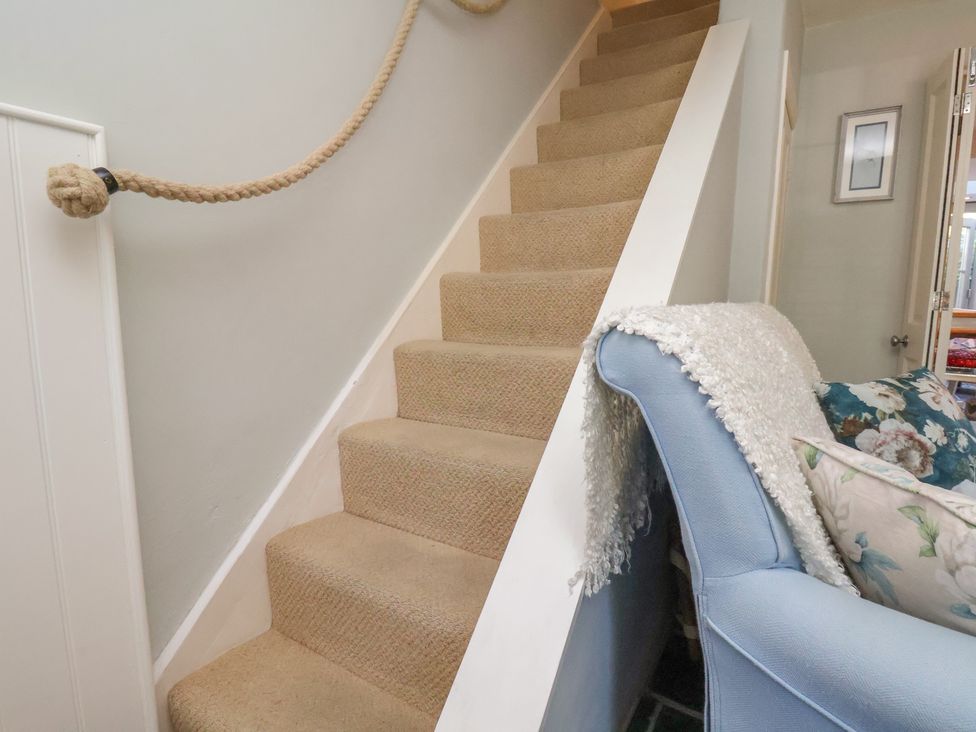 A staircase and sofa at Woodbine Cottage in Whitby