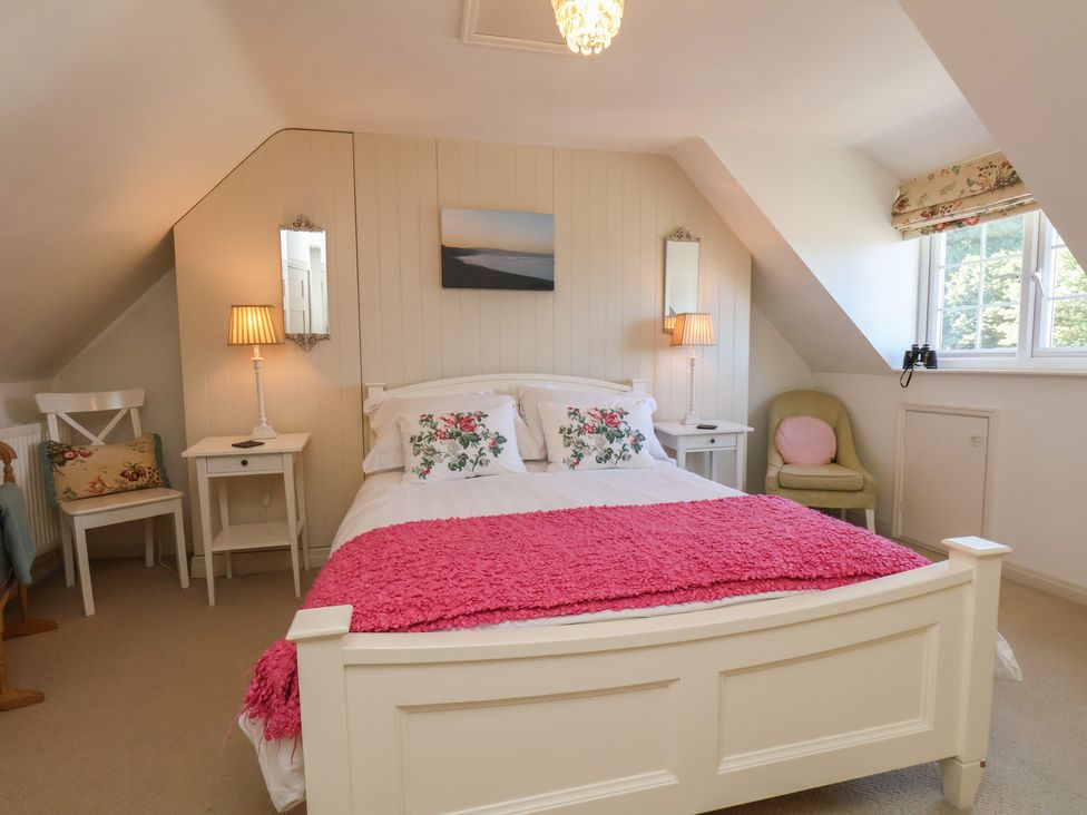 A bedroom with a bed and lamp at Woodbine Cottage in Whitby