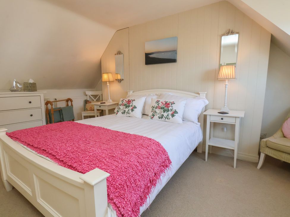 A bedroom with a bed and a chest of drawers at Woodbine Cottage in Whitby
