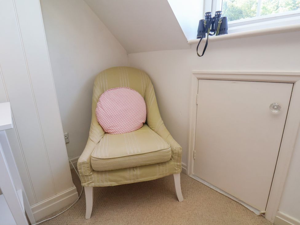 A chair with a cushion and binoculars at Woodbine Cottage in Whitby