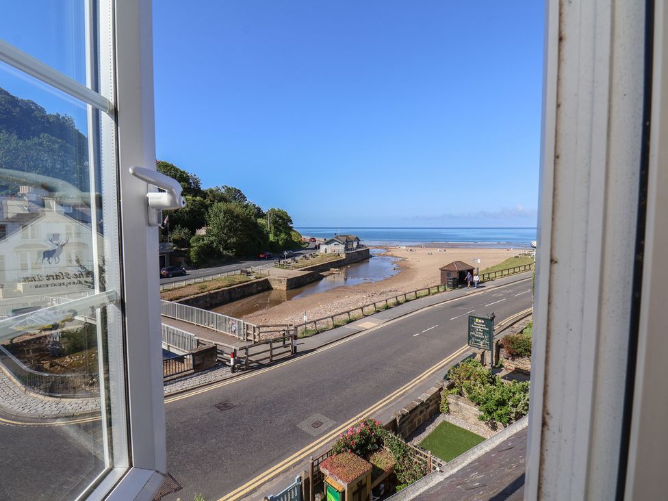 A view of the beach and road from a window at Woodbine Cottage in Whitby