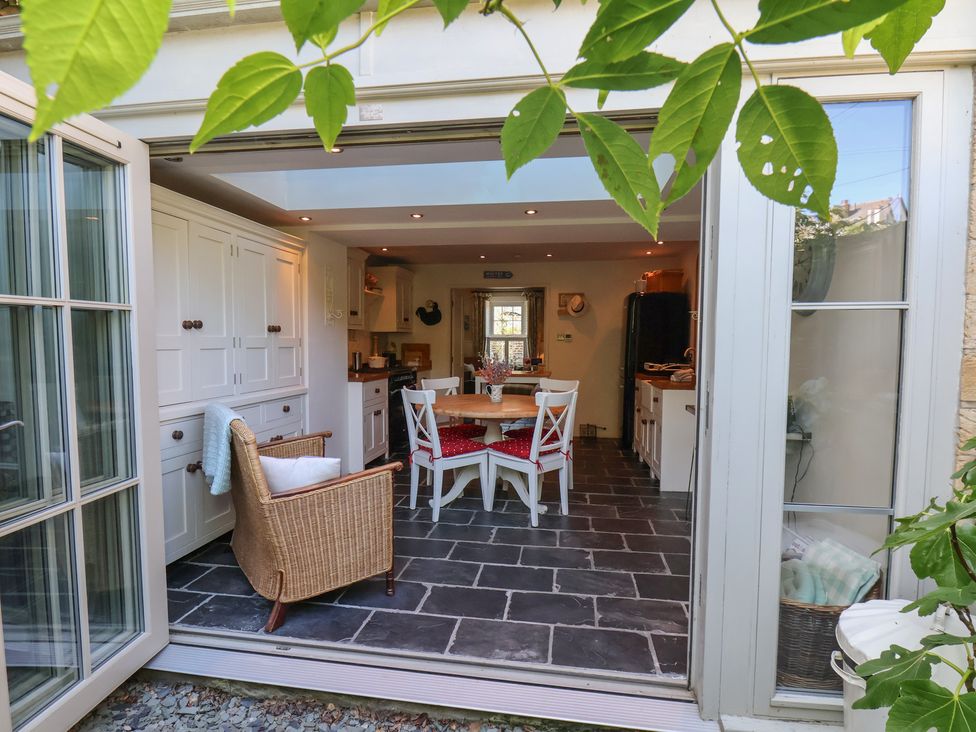 A kitchen with a dining table and chairs at Woodbine Cottage in Whitby