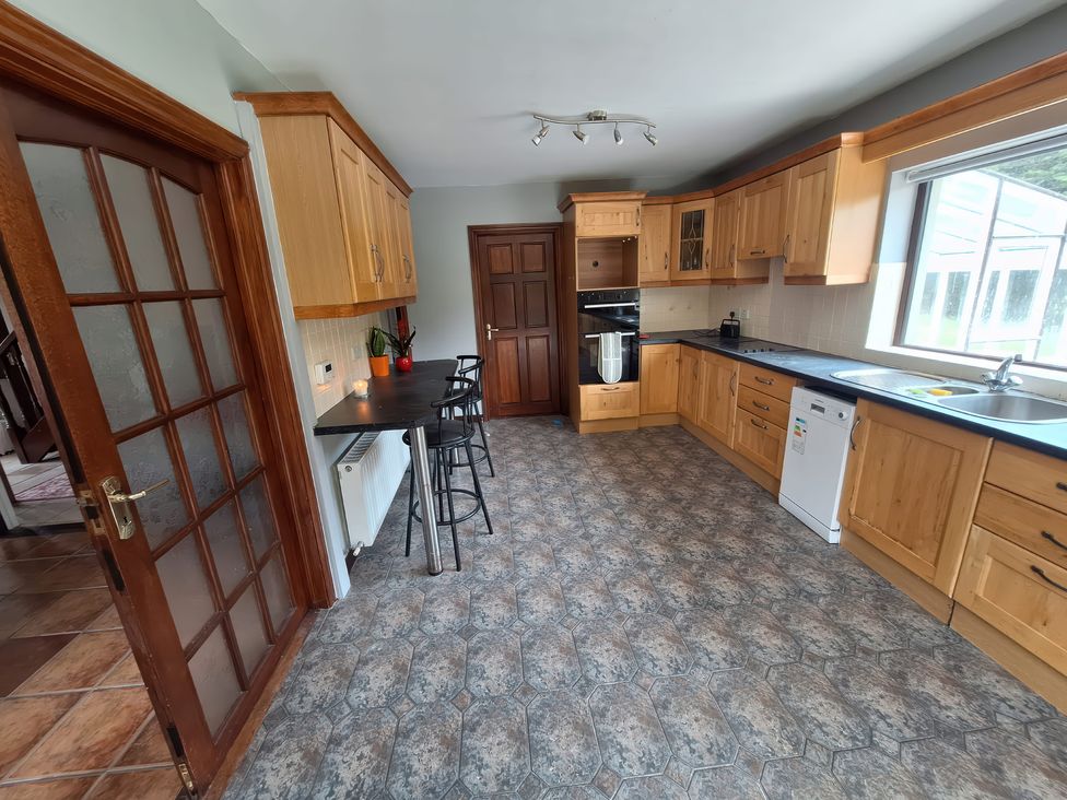 A kitchen with cabinets and a countertop at Lilly's Bungalow in Timoleague