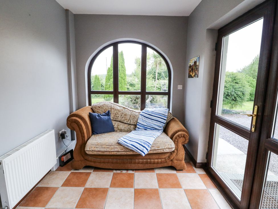 A snug with a sofa and window at Lilly's Bungalow in Clonakilty, County Cork