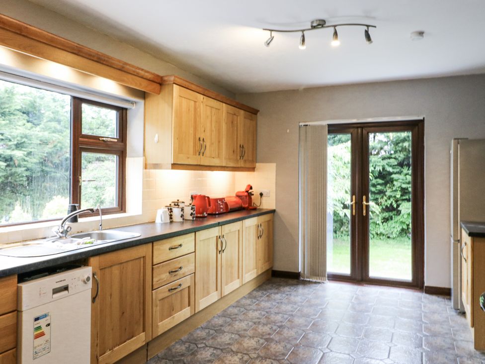 A kitchen with cabinets and sink at Lilly's Bungalow in Clonakilty, County Cork