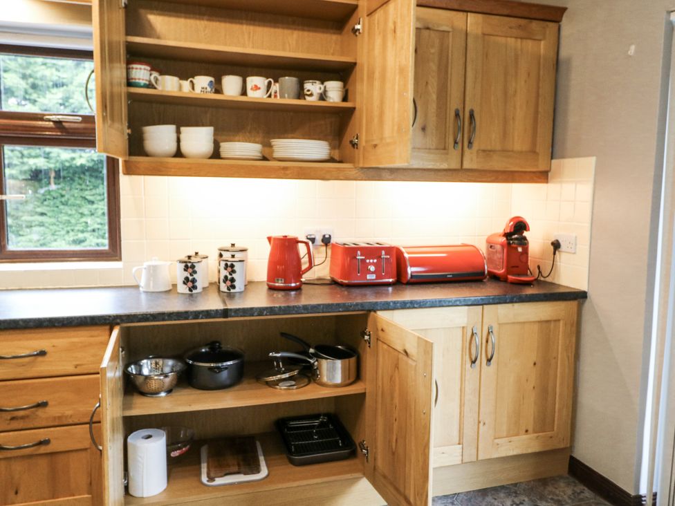 A kitchen with wooden cabinets and countertop at Lilly's Bungalow in Clonakilty, County Cork