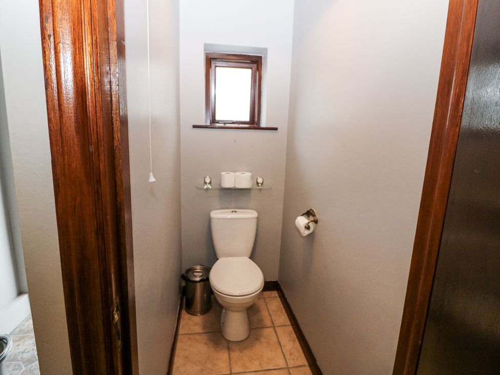 A bathroom with a toilet and sink at Lilly's Bungalow, Clonakilty, County Cork