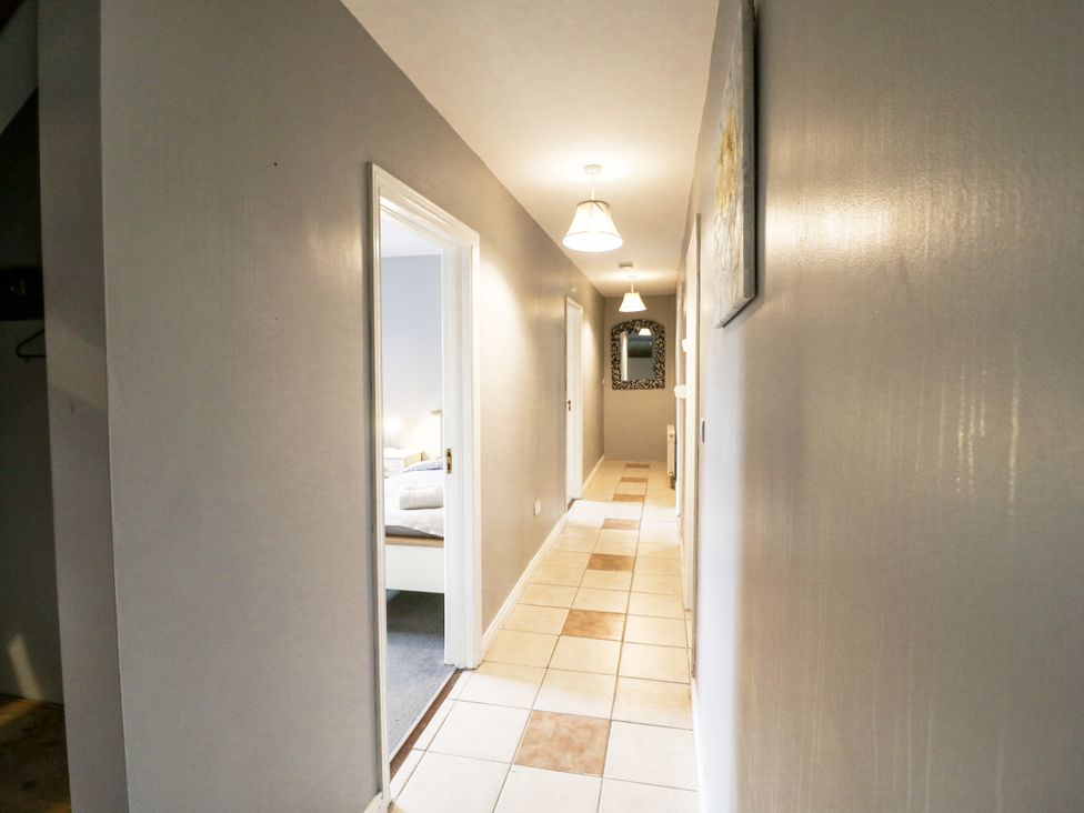 A hallway with light fixtures and doors at Lilly's Bungalow in Clonakilty, County Cork