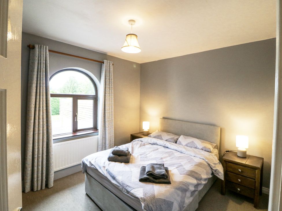 A bedroom with a bed and bedside tables at Lilly's Bungalow in Clonakilty, County Cork