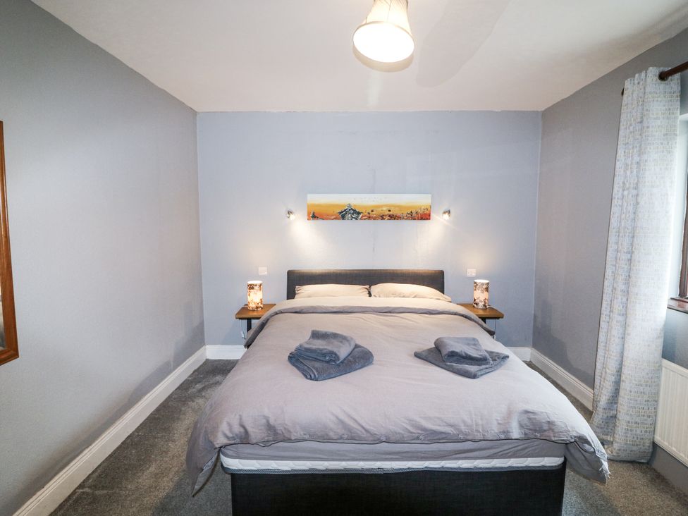 A bedroom with a bed and bedside table at Lilly's Bungalow in Clonakilty, County Cork