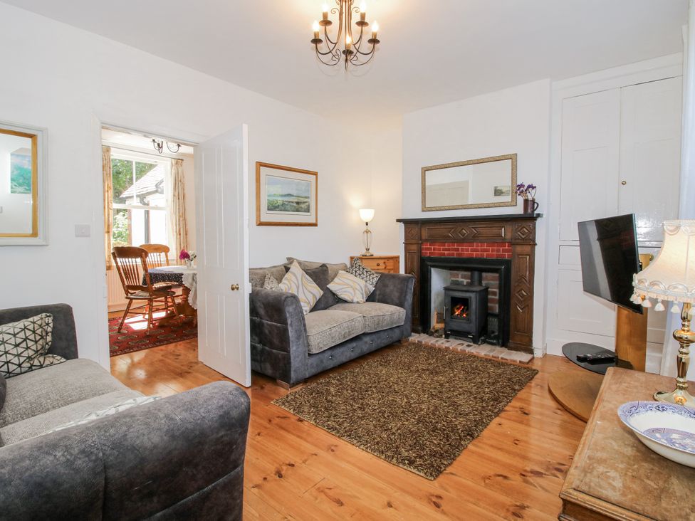 A living room with a fireplace and a sofa at 157 Watling Street South in Church Stretton