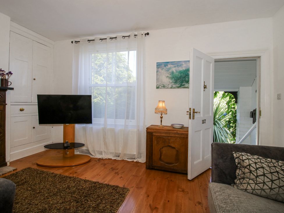 A living room with a television and a table at 157 Watling Street South, Church Stretton