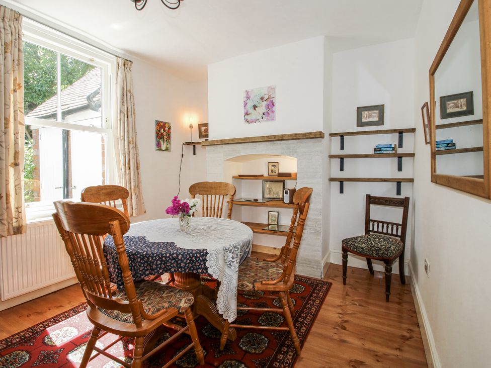A dining room with a round table and chairs at 157 Watling Street South Church Stretton