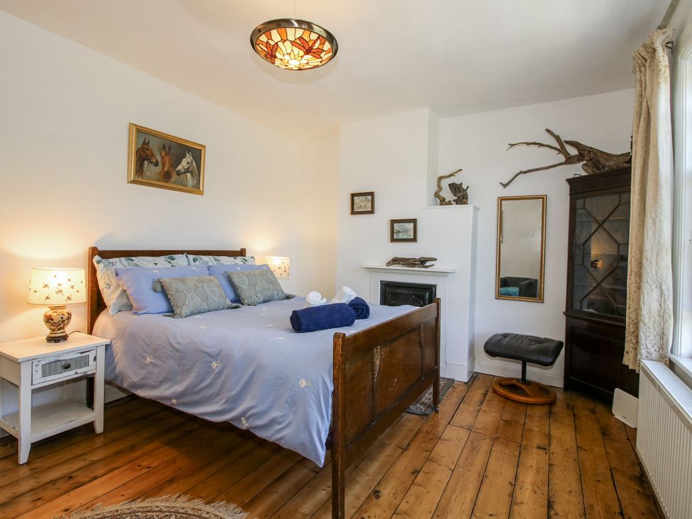 A bedroom with a bed and nightstand at 157 Watling Street South, Church Stretton