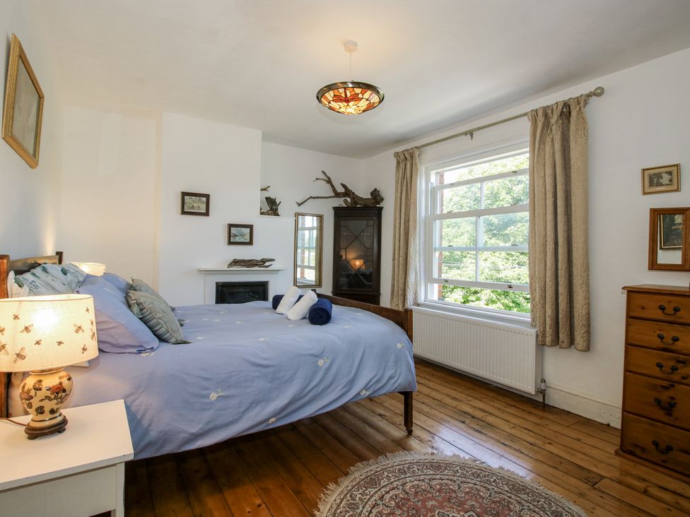 A bedroom with a bed and cupboard at 157 Watling Street South in Church Stretton