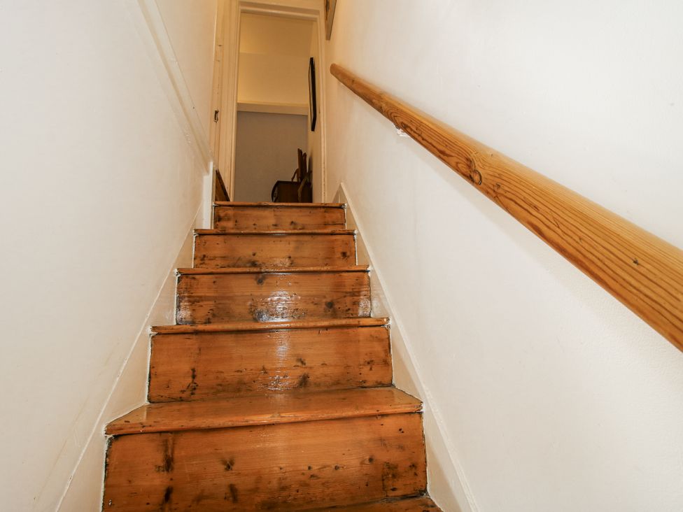 A staircase with wooden steps and a handrail at 157 Watling Street South Church Stretton