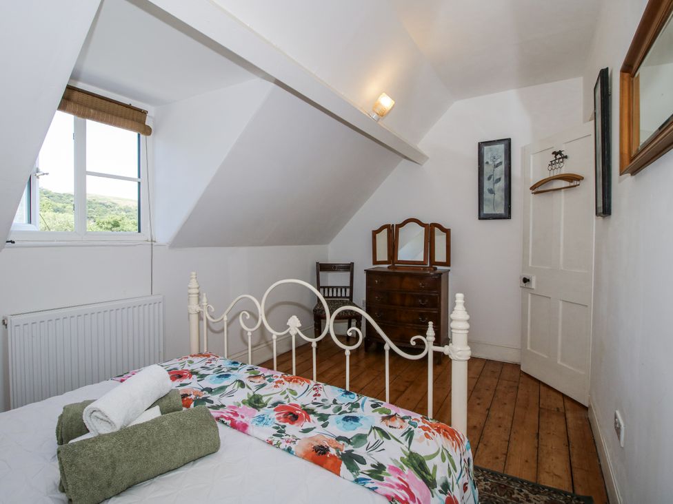 A bedroom with a bed and dressing table at 157 Watling Street South in Church Stretton