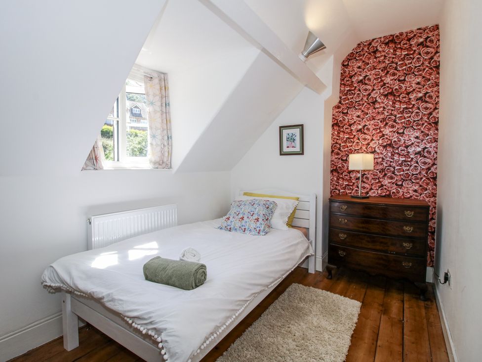 A bedroom with a bed and dresser at 157 Watling Street South in Church Stretton