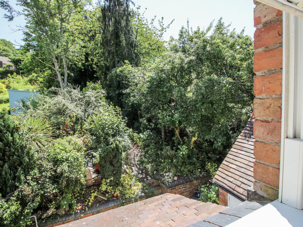 A view of a garden with trees and bushes at 157 Watling Street South, Church Stretton