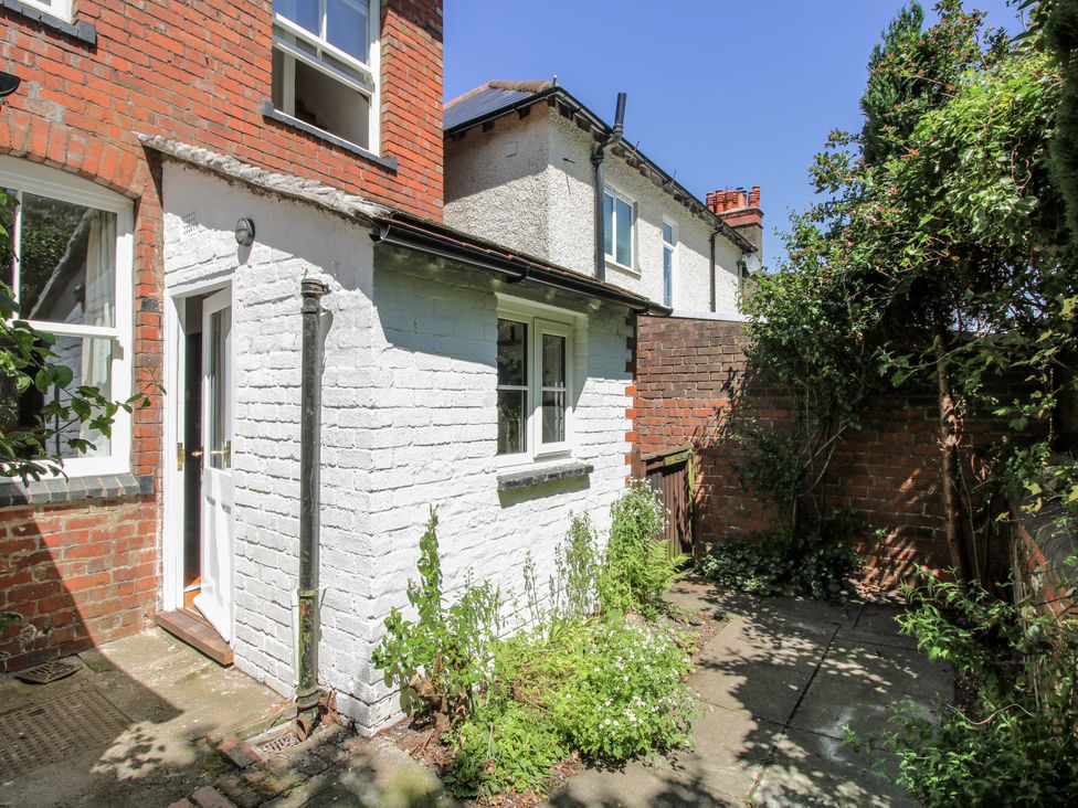 An outdoor area with a white wall and plants at 157 Watling Street South Church Stretton