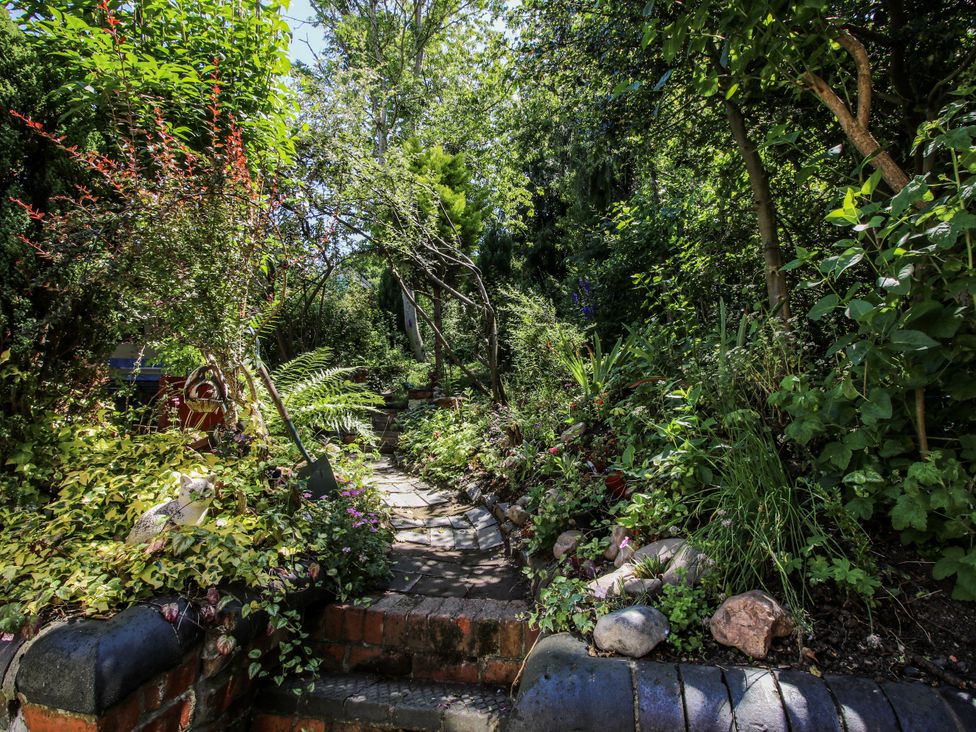 A garden path surrounded by plants and flowers at 157 Watling Street South Church Stretton