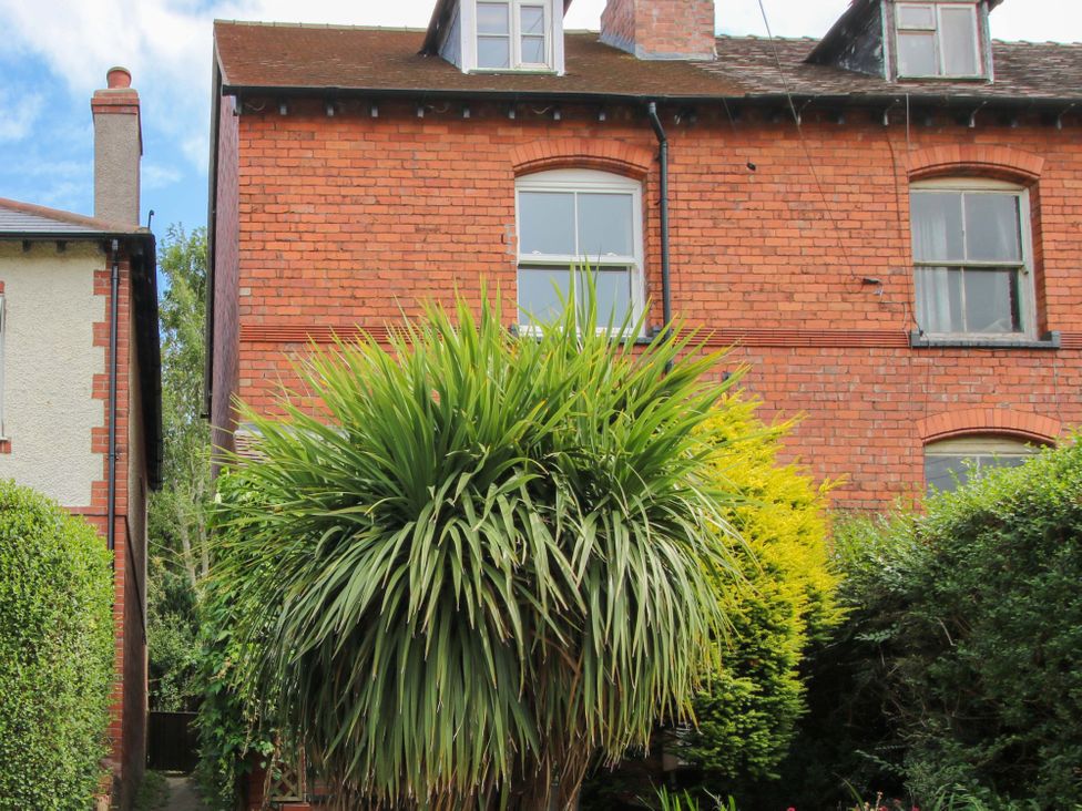 A house with a brick exterior and plants at 157 Watling Street South Church Stretton