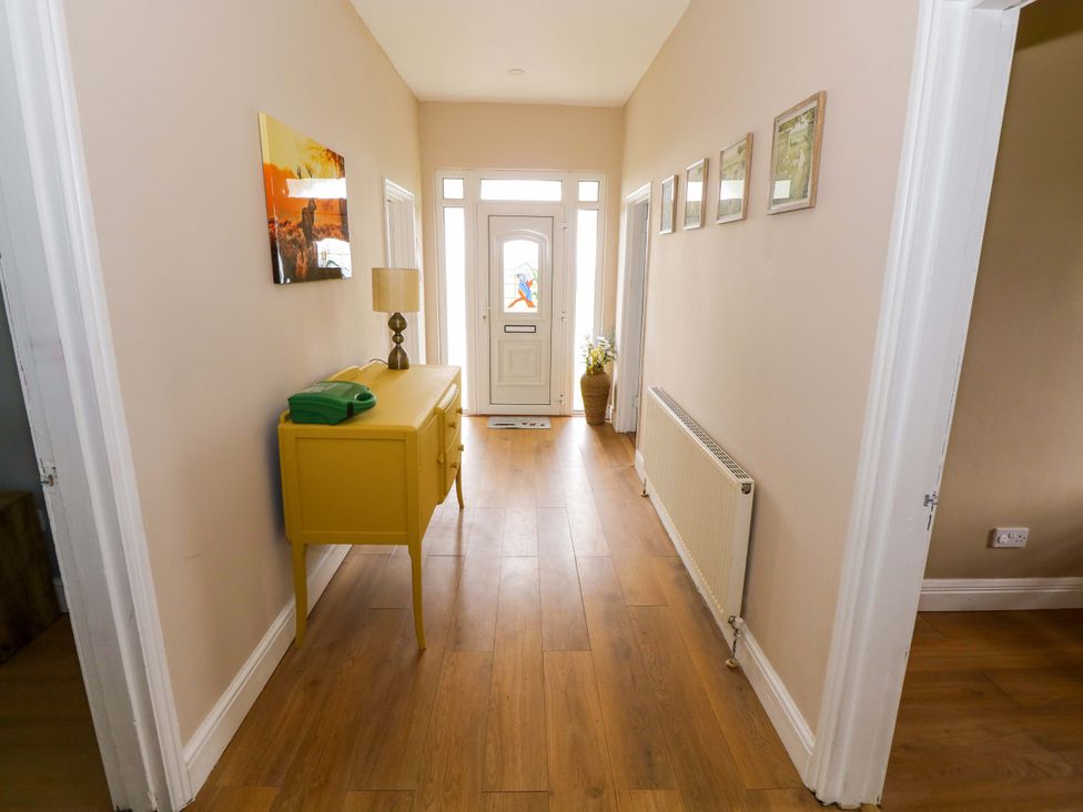 A hallway with a console table and lamp at CARROWREAGH
