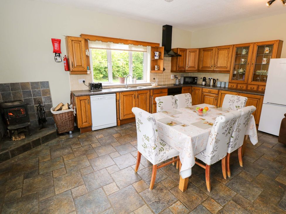 A kitchen with cabinets and dining area at CARROWREAGH