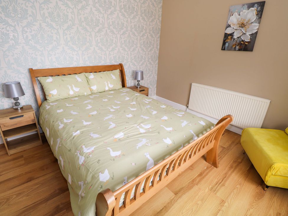 A bedroom with a bed and a chair at CARROWREAGH