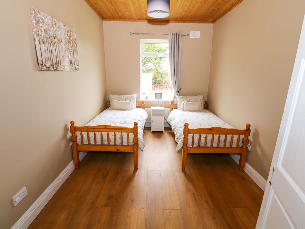 A bedroom with two beds and a window at CARROWREAGH