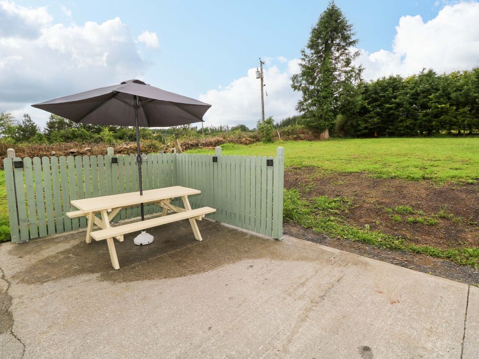 An outdoor area with a table and umbrella at CARROWREAGH