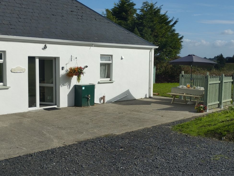 An outdoor area featuring a house with a door and table at Carrowreagh in Aclare, County Sligo