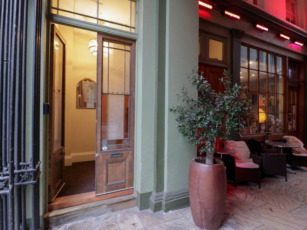 An entrance with a door, mirror, and plants at 12 Montpellier Arcade in Cheltenham