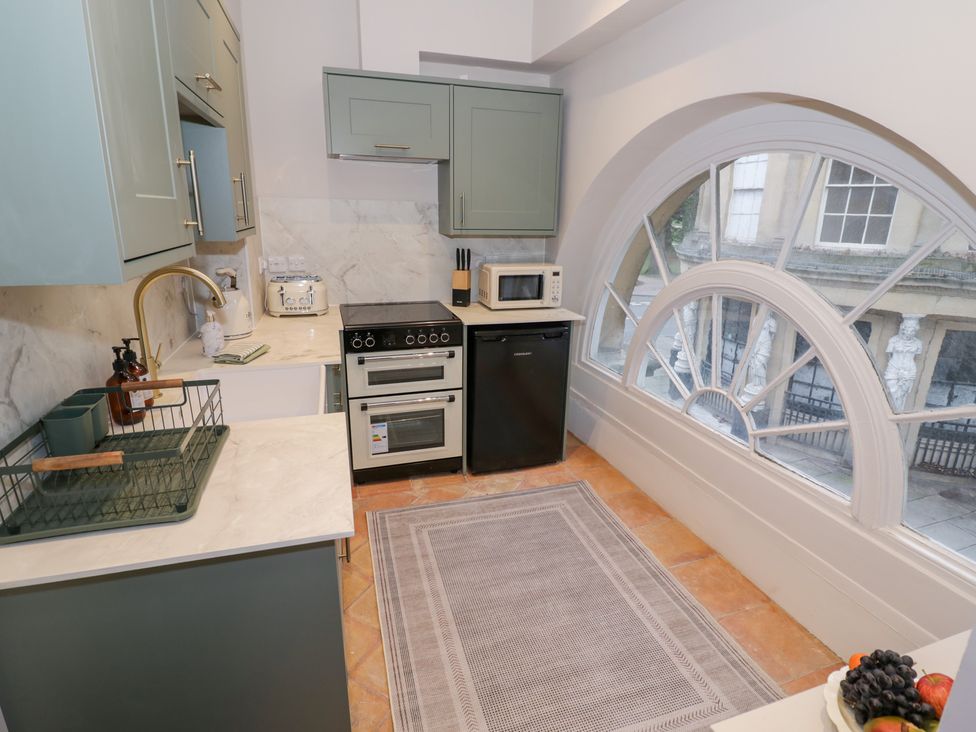 A kitchen with appliances and a sink at 12 Montpellier Arcade Cheltenham