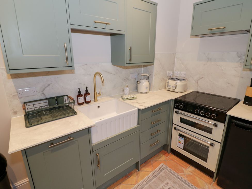 A kitchen with cabinets, sink and appliances at 12 Montpellier Arcade in Cheltenham