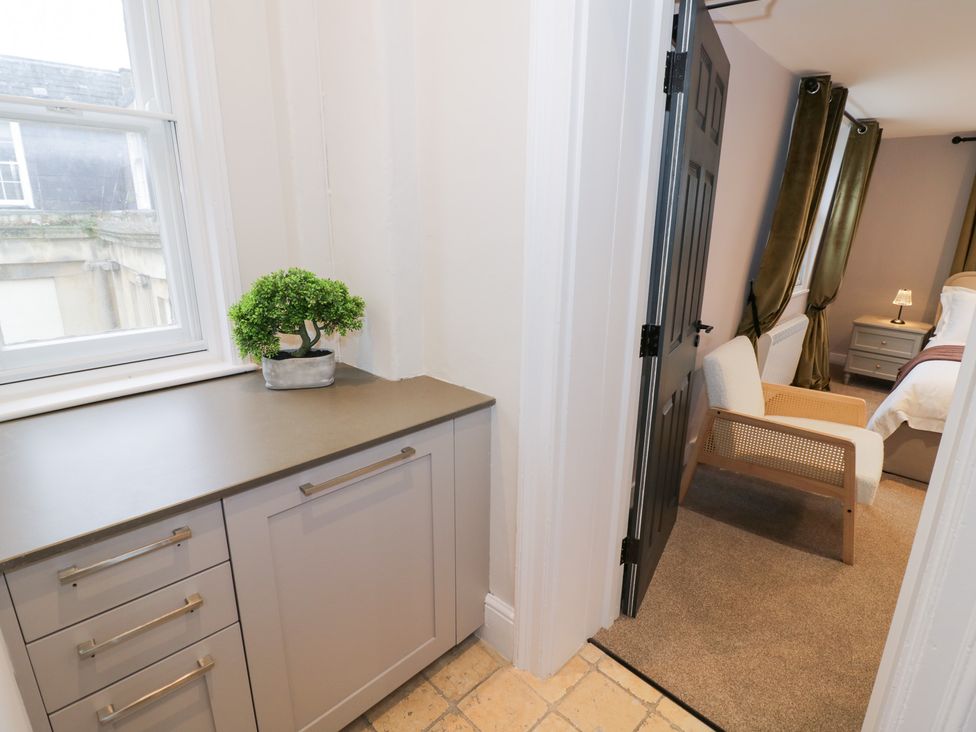 A hallway with a cabinet and plant at 12 Montpellier Arcade, Cheltenham
