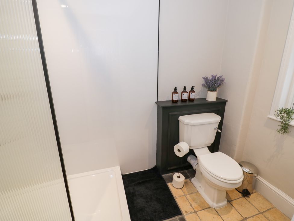 A bathroom with a toilet, sink, and shower at 12 Montpellier Arcade, Cheltenham