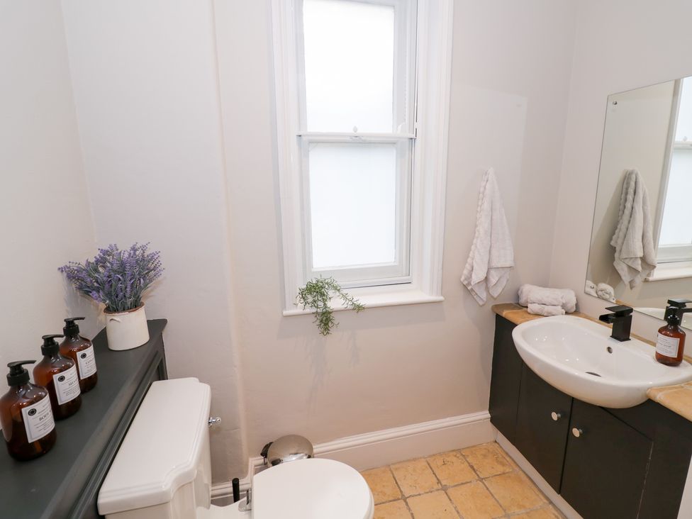 A bathroom with a toilet and sink at 12 Montpellier Arcade in Cheltenham