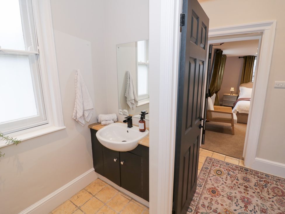 A bathroom with a sink and mirror at 12 Montpellier Arcade in Cheltenham