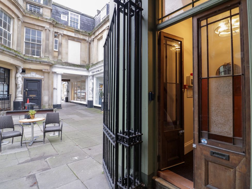A courtyard with tables and chairs at 12 Montpellier Arcade Cheltenham