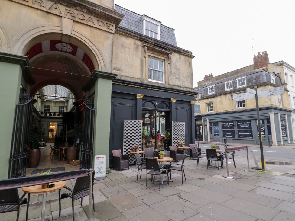 An outdoor area with tables and chairs at 12 Montpellier Arcade Cheltenham