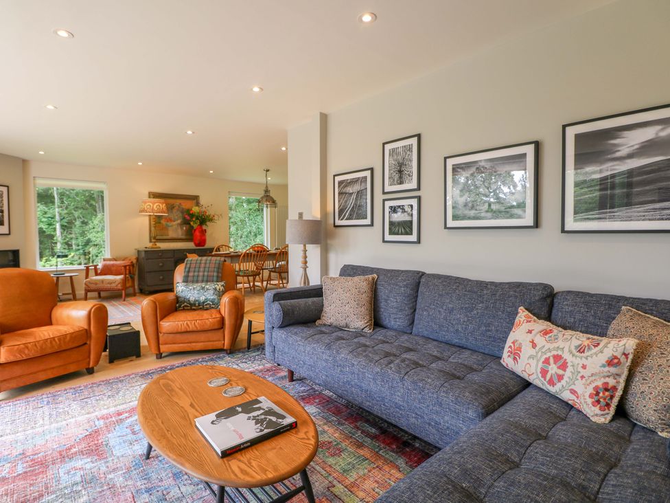 A living room with a sofa and armchairs at Lakeside Lodge Witherenden Hill near Burwash